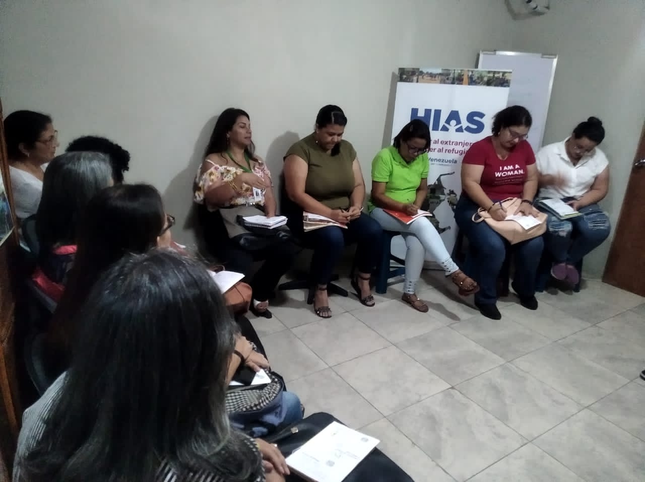 people holding umbrellas on a busy street at night lit by street lights and illuminated signs in Tokyo, Japan